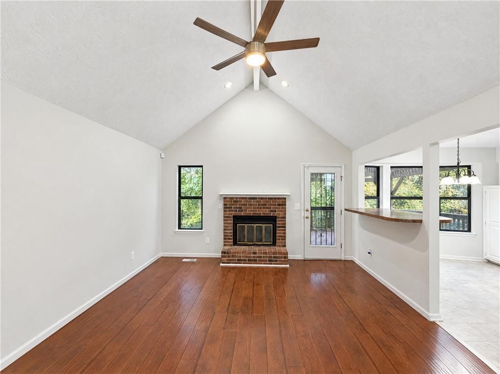 Tall ceilings, fireplace and brick fireplace at 14416 Saint Andrews Drive, Grandview, MO 64030